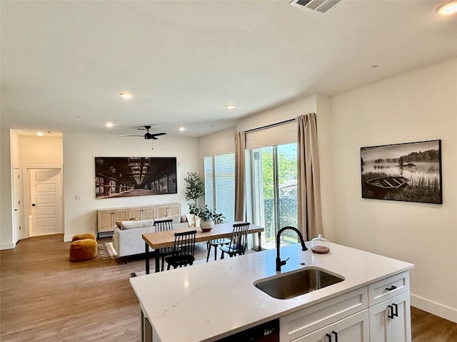 1811 Webberville Rd Unit 1206, Austin, TX 78721 - kitchen with a sink, a ceiling fan, recessed lighting, wood finished floors, and baseboards