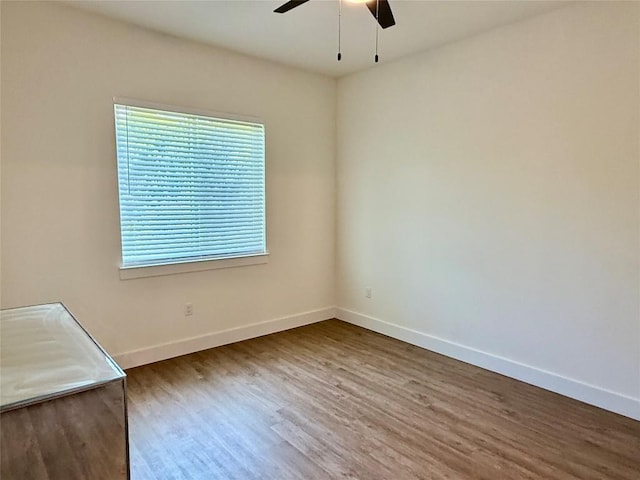 1811 Webberville Rd Unit 1206, Austin, TX 78721 - unfurnished room with a ceiling fan, wood finished floors, and baseboards