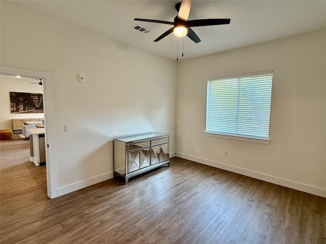 1811 Webberville Rd Unit 1206, Austin, TX 78721 - empty room featuring ceiling fan, baseboards, and wood finished floors