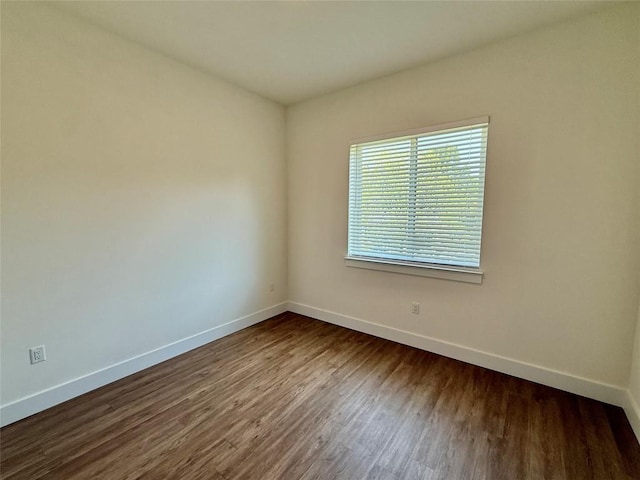 1811 Webberville Rd Unit 1206, Austin, TX 78721 - unfurnished room featuring baseboards and dark wood finished floors