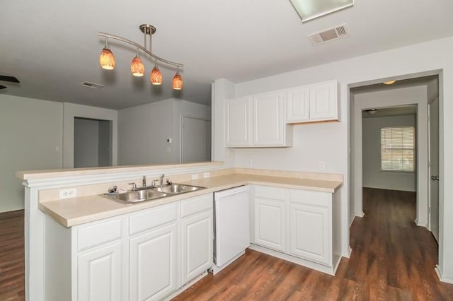 13604 Sierra Wind Ln, Elgin, TX 78621 - kitchen with dishwasher, a peninsula, dark wood-type flooring, light countertops, and white cabinets