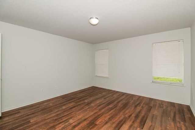 13604 Sierra Wind Ln, Elgin, TX 78621 - spare room featuring dark wood-type flooring and baseboards