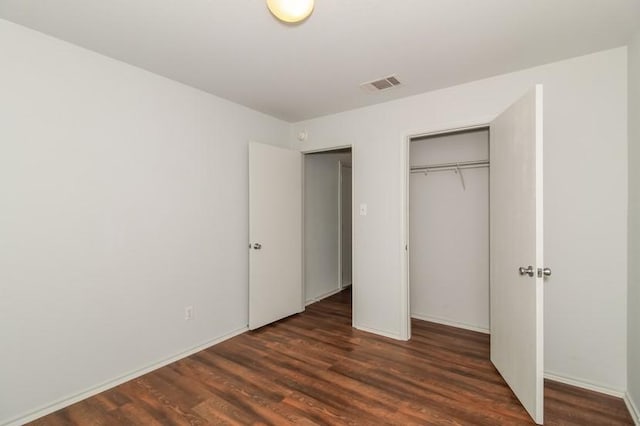 13604 Sierra Wind Ln, Elgin, TX 78621 - unfurnished bedroom with a closet and dark wood-style flooring