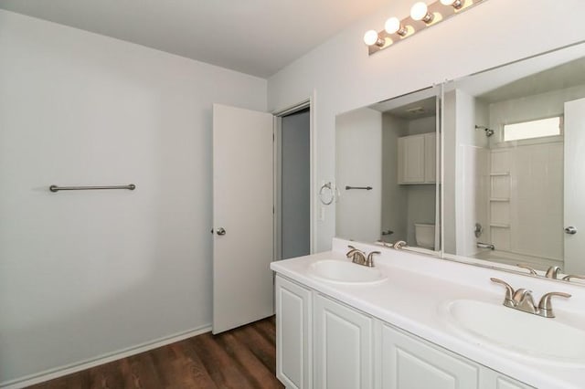 13604 Sierra Wind Ln, Elgin, TX 78621 - bathroom featuring double vanity, wood finished floors, and washtub / shower combination