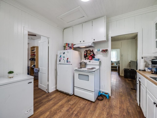 kitchen with ornamental molding, white appliances, dark wood-style floors, wood walls, and under cabinet range hood