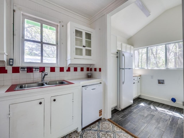 kitchen featuring white appliances, white cabinetry, crown molding, decorative backsplash, and a sink
