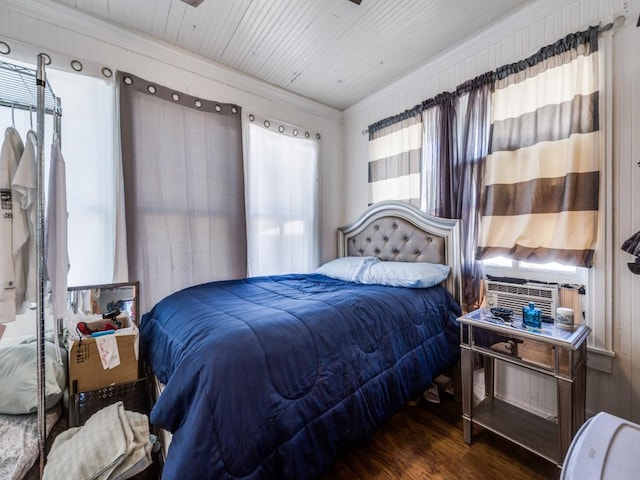 bedroom with ornamental molding, cooling unit, and wood finished floors