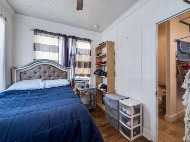 bedroom featuring wood walls, crown molding, and wood finished floors