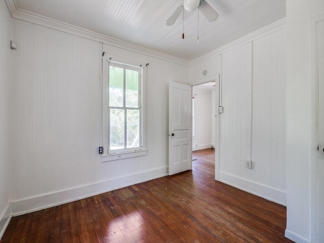 empty room featuring ceiling fan, baseboards, ornamental molding, and hardwood / wood-style flooring