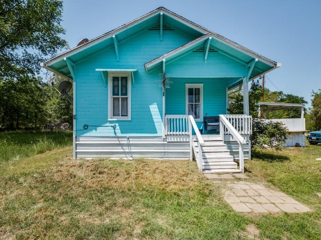bungalow-style house featuring a porch and a front lawn