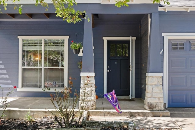 2025 Wayward Sun Dr, Austin, TX 78754 - doorway to property with covered porch and a garage