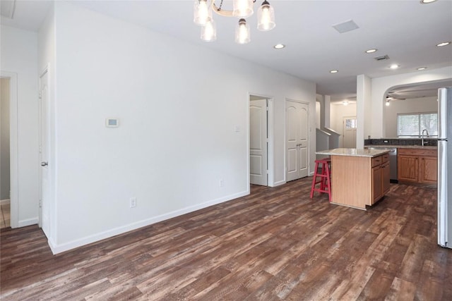 2025 Wayward Sun Dr, Austin, TX 78754 - kitchen featuring dark wood-style floors, a kitchen bar, dishwasher, a chandelier, and recessed lighting