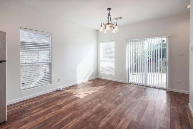 2025 Wayward Sun Dr, Austin, TX 78754 - unfurnished room featuring wood finished floors and a chandelier