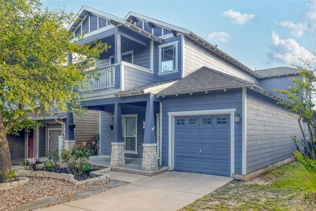 2025 Wayward Sun Dr, Austin, TX 78754 - craftsman-style house featuring a balcony, driveway, covered porch, roof with shingles, and an attached garage
