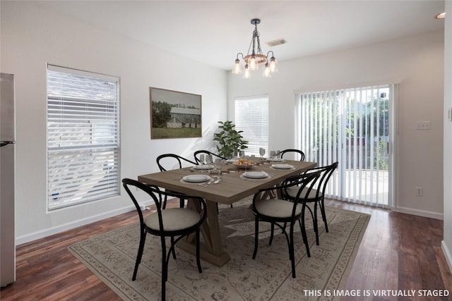 2025 Wayward Sun Dr, Austin, TX 78754 - dining space with a chandelier, plenty of natural light, and wood finished floors