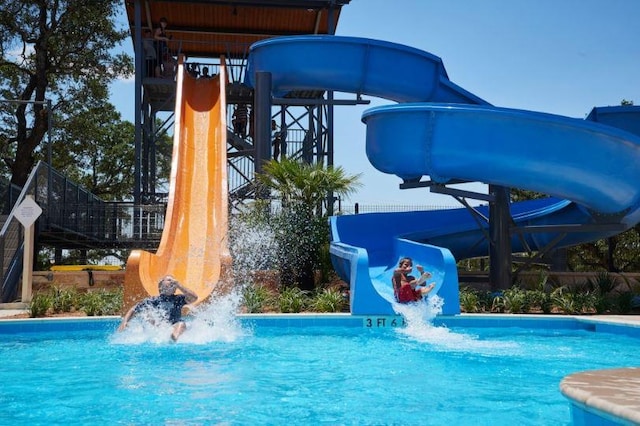 outdoor pool featuring a water slide