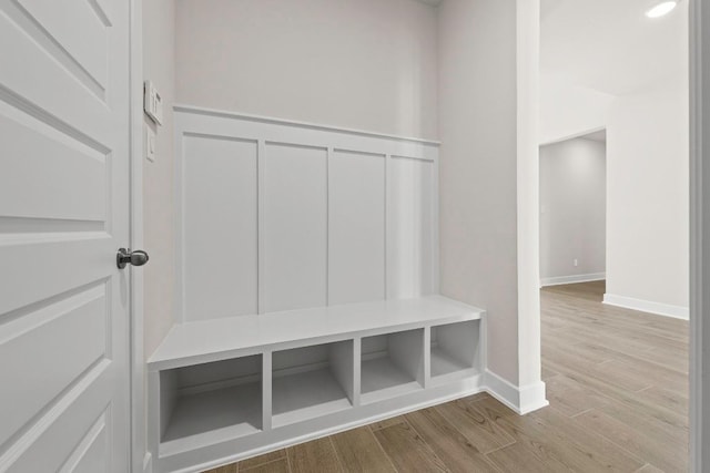 212 Ranchland Pass, Liberty Hill, TX 78642 - mudroom with wood finished floors, baseboards, and a decorative wall