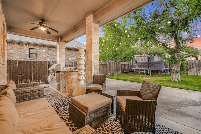 view of patio / terrace featuring area for grilling, ceiling fan, a fenced backyard, and a trampoline