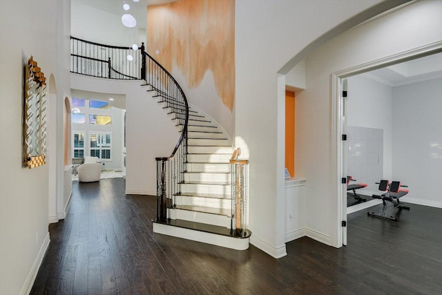 132 Archipelago Trl, Austin, TX 78717 - stairs with arched walkways, wood finished floors, a towering ceiling, and ornamental molding