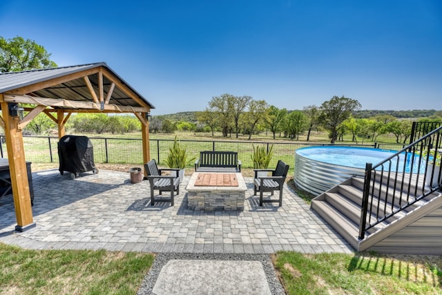 452 Sandy Cemetery Rd, Johnson City, TX 78636 - view of patio / terrace with a grill, a fire pit, a gazebo, fence, and a fenced in pool
