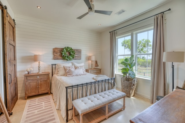 452 Sandy Cemetery Rd, Johnson City, TX 78636 - bedroom featuring visible vents, baseboards, a barn door, wooden walls, and recessed lighting
