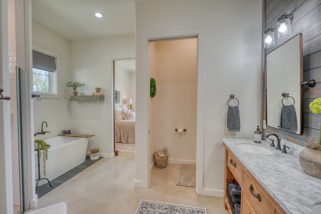 452 Sandy Cemetery Rd, Johnson City, TX 78636 - ensuite bathroom featuring vanity, baseboards, recessed lighting, ensuite bathroom, and a freestanding bath