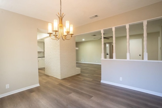 empty room featuring dark wood-style flooring, visible vents, baseboards, and ceiling fan with notable chandelier
