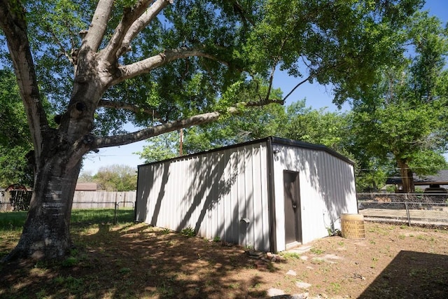 view of shed featuring fence
