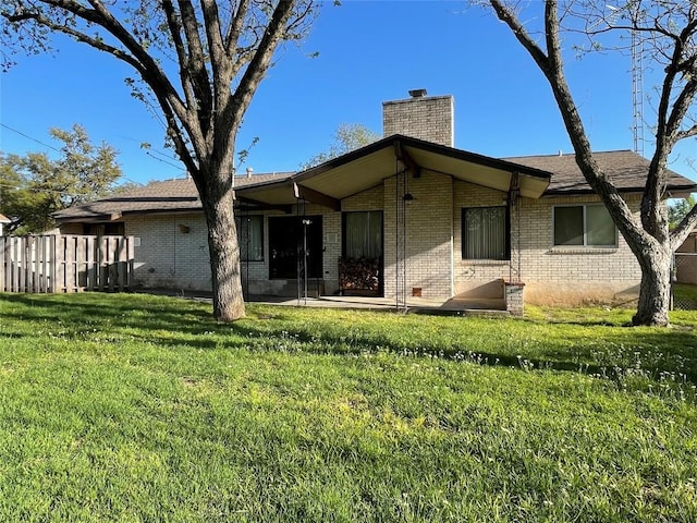 604 E Kerr St, Burnet, TX 78611 - back of property with a chimney and brick siding