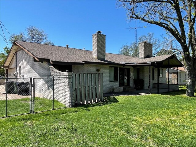 604 E Kerr St, Burnet, TX 78611 - rear view of property with brick siding, a chimney, a patio area, and a shingled roof