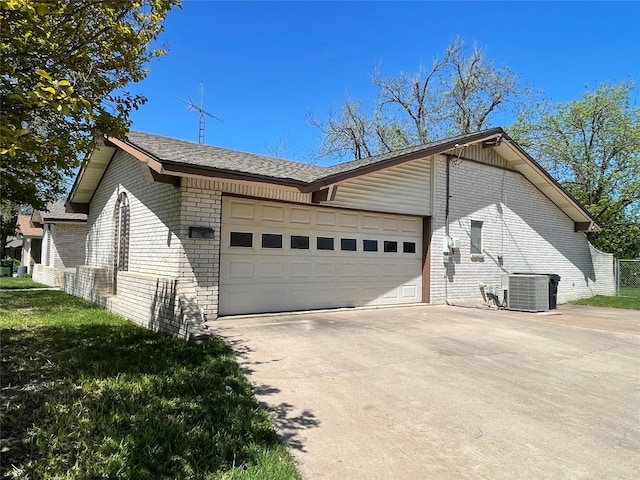 604 E Kerr St, Burnet, TX 78611 - view of property exterior featuring brick siding, an attached garage, concrete driveway, and a shingled roof