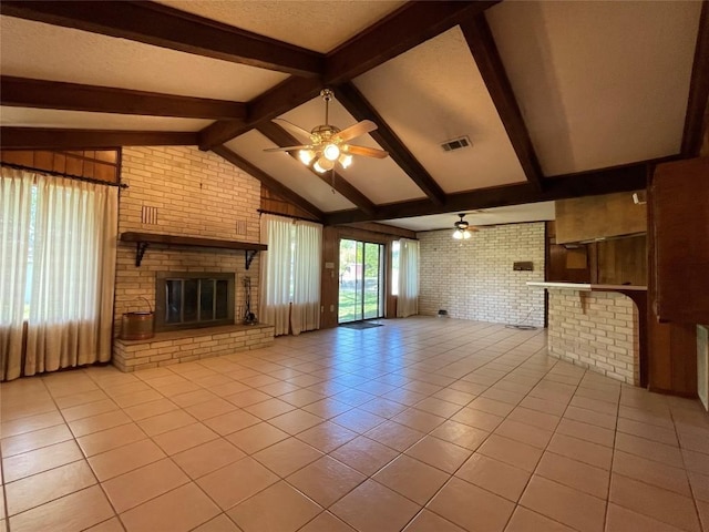 604 E Kerr St, Burnet, TX 78611 - unfurnished living room with brick wall, light tile patterned flooring, ceiling fan, and a fireplace