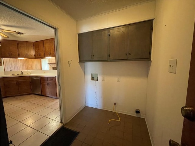 604 E Kerr St, Burnet, TX 78611 - laundry room with washer hookup, a textured ceiling, a ceiling fan, light tile patterned floors, and cabinet space