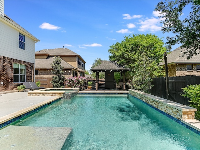 view of swimming pool featuring a gazebo, a pool with connected hot tub, a fenced backyard, and a patio area