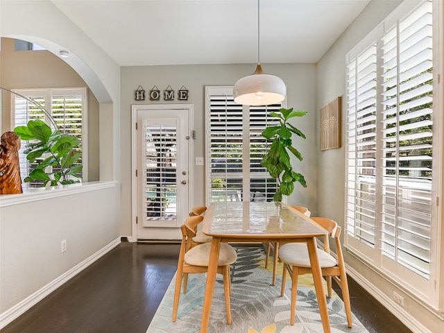 dining area featuring baseboards and wood finished floors