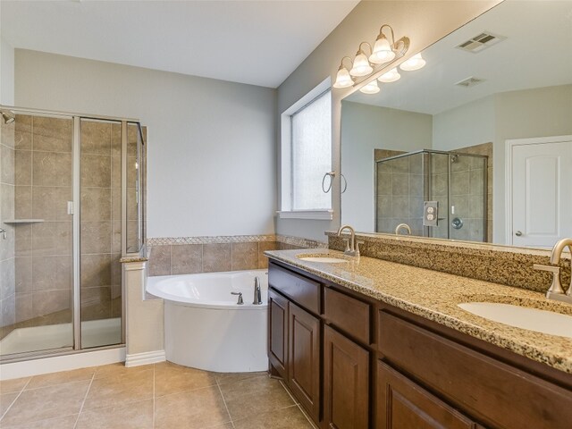 bathroom with tile patterned floors, visible vents, a sink, and a stall shower