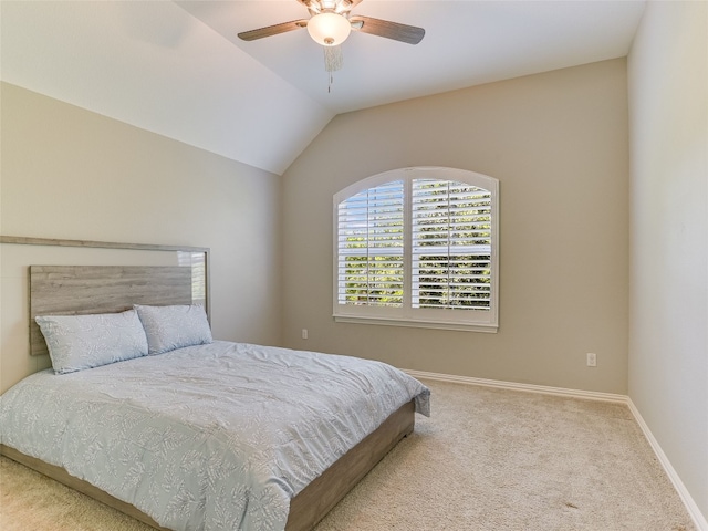 carpeted bedroom with baseboards, vaulted ceiling, and a ceiling fan