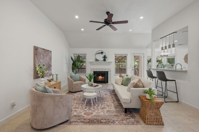 510 Sunny Brook Dr, Leander, TX 78641 - living room with a fireplace, recessed lighting, ceiling fan, vaulted ceiling, and tile patterned flooring