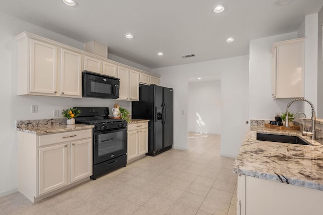 510 Sunny Brook Dr, Leander, TX 78641 - kitchen with black appliances, light stone counters, recessed lighting, and light tile patterned flooring