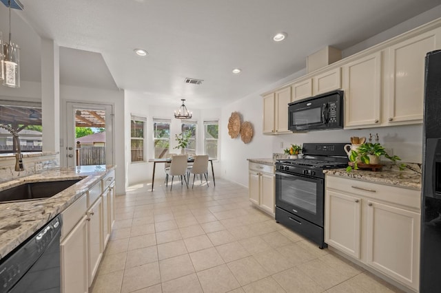 510 Sunny Brook Dr, Leander, TX 78641 - kitchen featuring black appliances, a chandelier, recessed lighting, light tile patterned floors, and decorative light fixtures