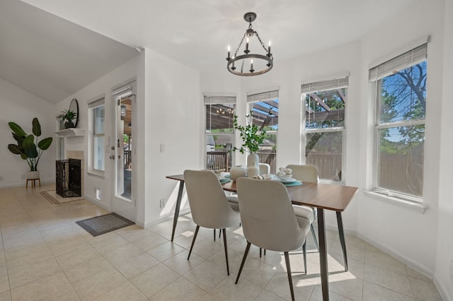 510 Sunny Brook Dr, Leander, TX 78641 - dining space with a chandelier, light tile patterned floors, and a fireplace with raised hearth