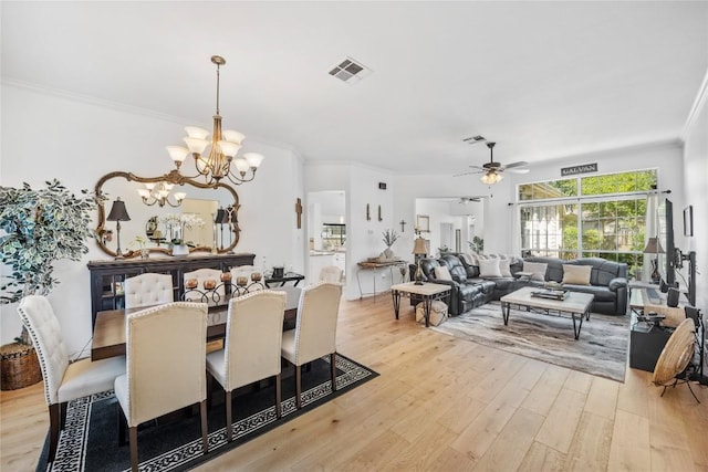 4010 Halfway Cv, Round Rock, TX 78681 - dining area featuring light wood-style floors, visible vents, ceiling fan with notable chandelier, and ornamental molding