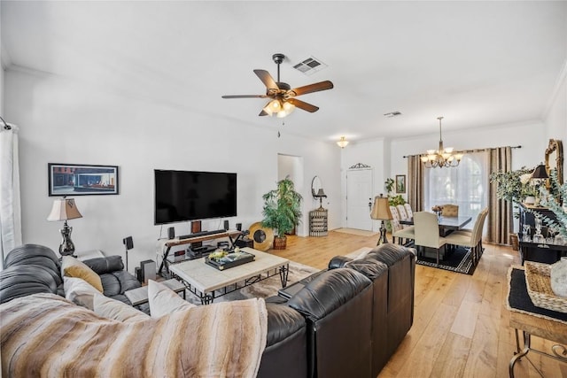 4010 Halfway Cv, Round Rock, TX 78681 - living area featuring light wood-type flooring, crown molding, visible vents, and ceiling fan with notable chandelier