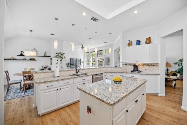 4010 Halfway Cv, Round Rock, TX 78681 - kitchen with a peninsula, a center island, visible vents, dishwasher, and a sink