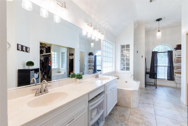 4010 Halfway Cv, Round Rock, TX 78681 - full bathroom featuring a garden tub, double vanity, a sink, and a walk in closet