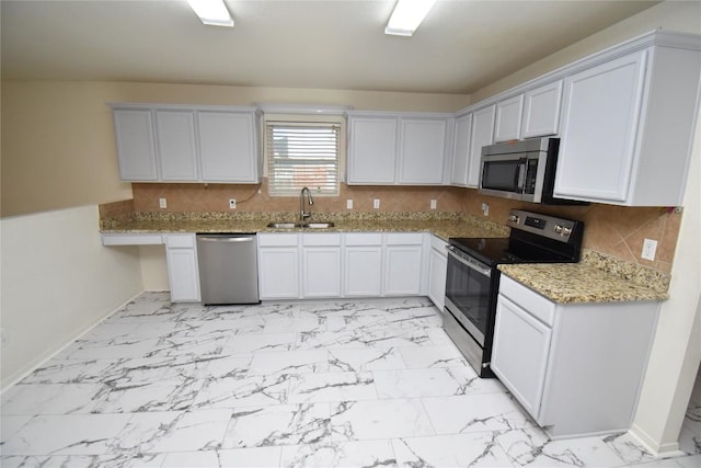 2305 Love Rd, Killeen, TX 76542 - kitchen with appliances with stainless steel finishes, a sink, light marble finish flooring, baseboards, and light stone counters
