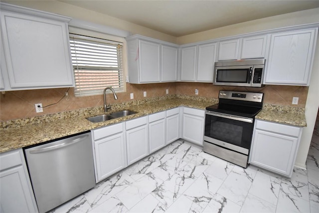 2305 Love Rd, Killeen, TX 76542 - kitchen featuring appliances with stainless steel finishes, a sink, light marble finish floors, and backsplash