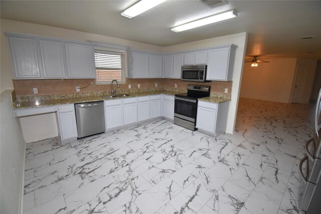 2305 Love Rd, Killeen, TX 76542 - kitchen featuring appliances with stainless steel finishes, a sink, light marble finish floors, and light stone countertops
