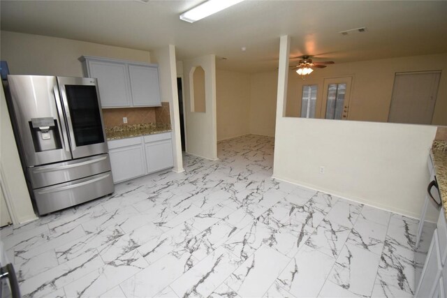 2305 Love Rd, Killeen, TX 76542 - kitchen featuring stainless steel fridge with ice dispenser, ceiling fan, light marble finish floors, and decorative backsplash