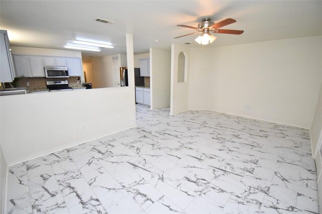 2305 Love Rd, Killeen, TX 76542 - kitchen with stainless steel appliances, a ceiling fan, light marble finish floors, and a peninsula